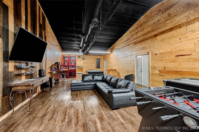 living room featuring wood-type flooring and wooden walls