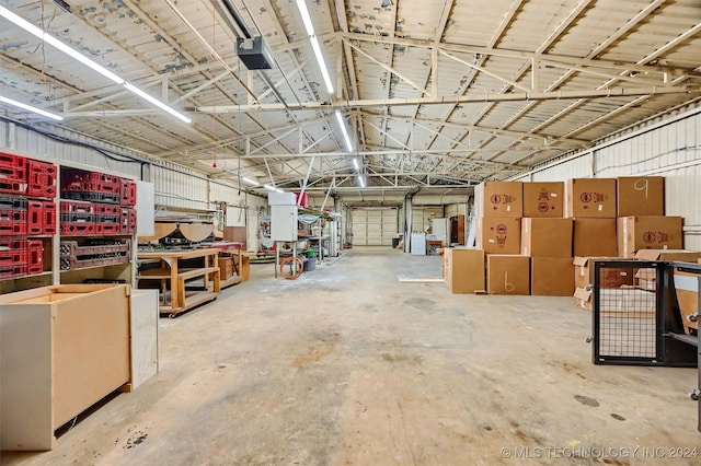 garage featuring a garage door opener and metal wall