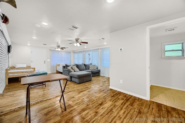 living room featuring hardwood / wood-style floors and ceiling fan