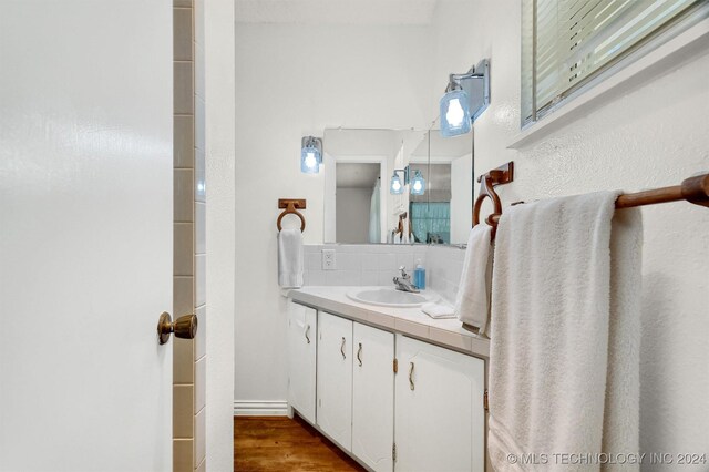 bathroom with hardwood / wood-style floors and vanity