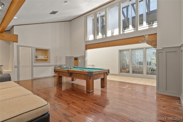 recreation room with beam ceiling, high vaulted ceiling, pool table, crown molding, and hardwood / wood-style floors