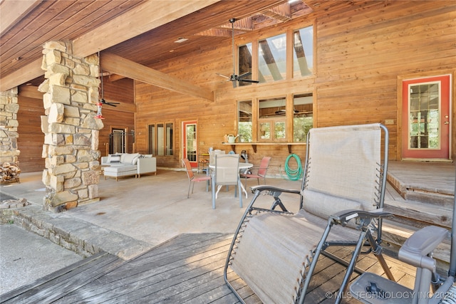 wooden deck with outdoor lounge area and ceiling fan