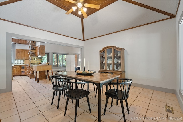 dining area featuring a textured ceiling, light tile patterned floors, vaulted ceiling, and ceiling fan