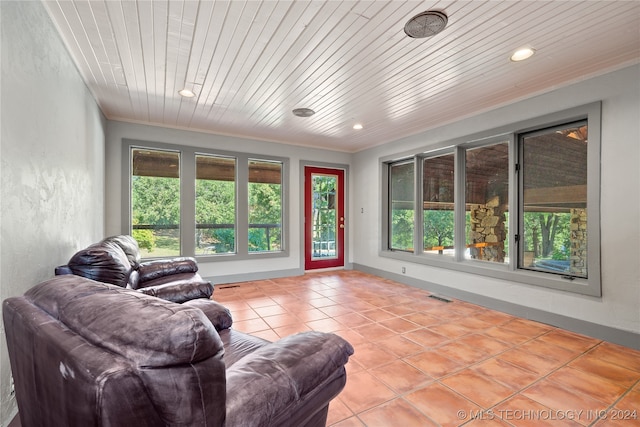 living room featuring wooden ceiling, crown molding, and light tile patterned floors