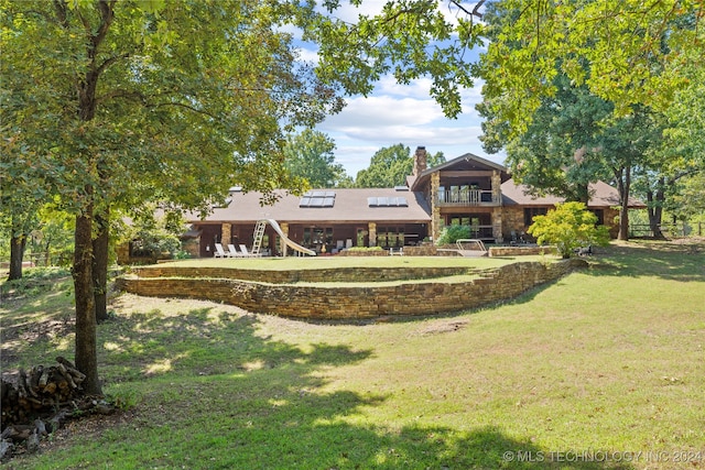 rear view of property featuring a yard