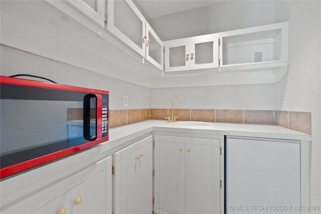 kitchen featuring white cabinets and sink