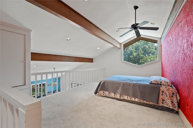 bedroom featuring ceiling fan, a textured ceiling, lofted ceiling with beams, and carpet flooring