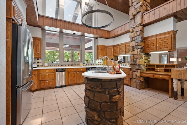 kitchen with light tile patterned flooring, sink, stainless steel fridge with ice dispenser, and high vaulted ceiling