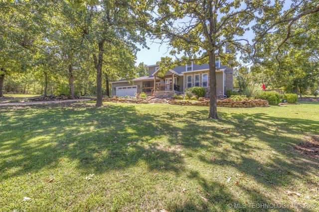 view of front of house featuring a garage and a front lawn