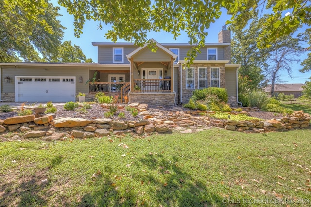 view of front of home featuring a garage, a porch, and a front yard