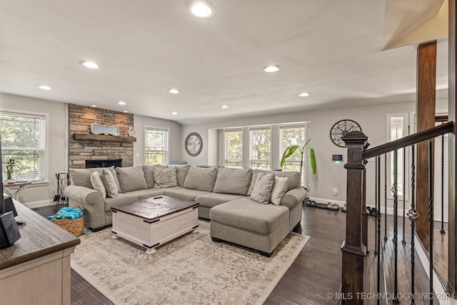 living room featuring a fireplace and dark wood-type flooring