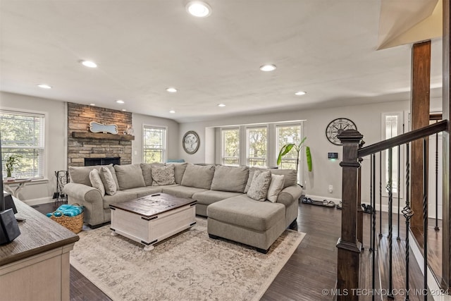 living area featuring stairway, dark wood-style flooring, and a wealth of natural light