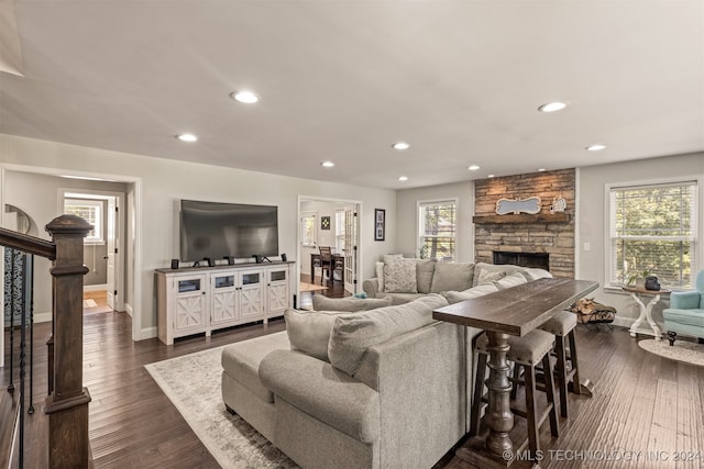 living room featuring a fireplace and dark wood-type flooring