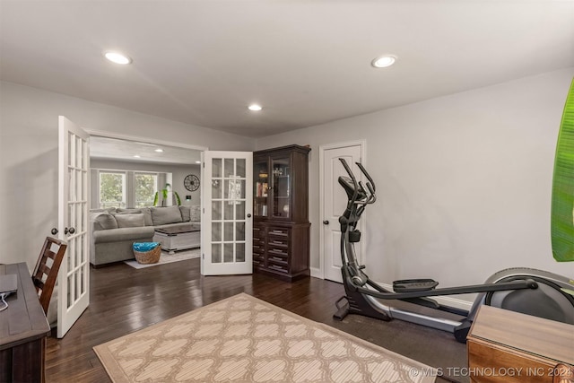 workout room with dark wood-style floors, recessed lighting, and french doors