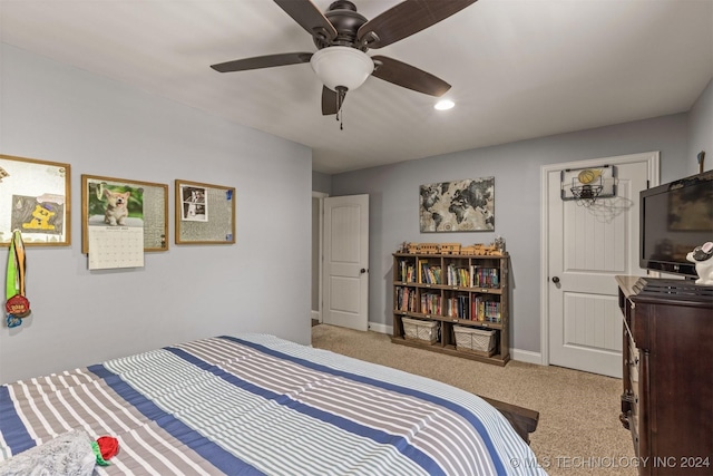 bedroom with a ceiling fan, light colored carpet, and baseboards