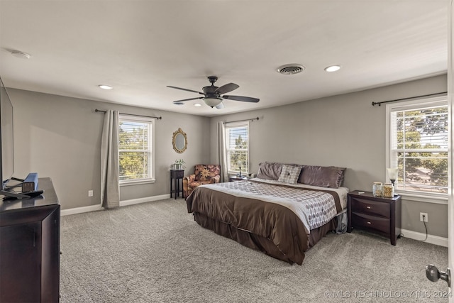 bedroom with light carpet, baseboards, visible vents, and a ceiling fan