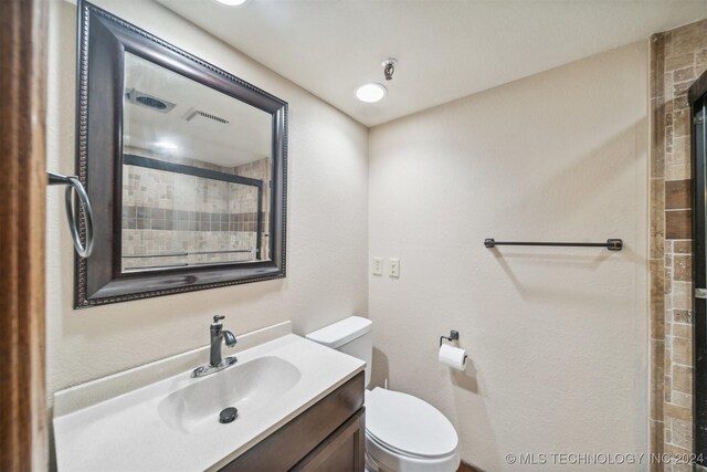 bathroom with toilet and vanity