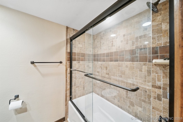 bathroom featuring combined bath / shower with glass door