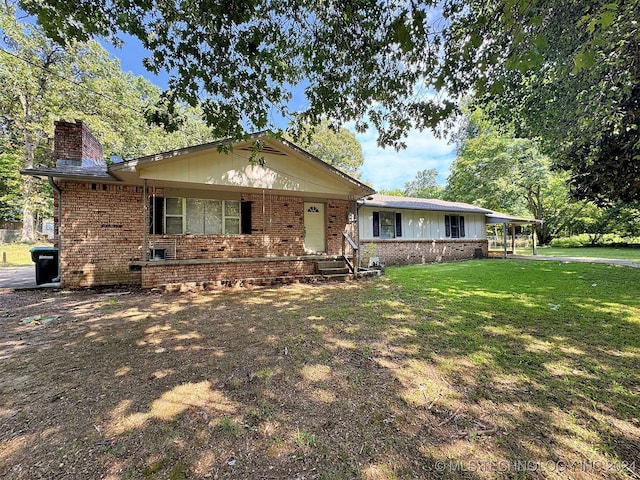 single story home featuring a carport and a front yard