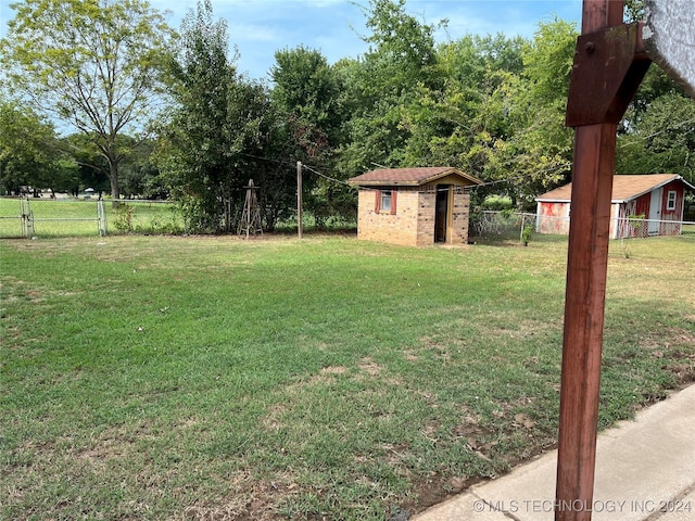2912 Michelle, Durant, OK 74701 - view of yard featuring a storage shed, a fenced backyard, and an outdoor structure
