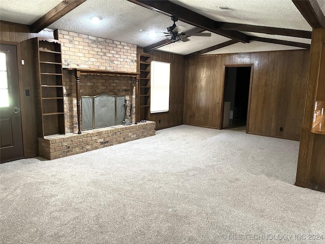 2912 Michelle, Durant, OK 74701 - unfurnished living room featuring a textured ceiling, wood walls, and carpet