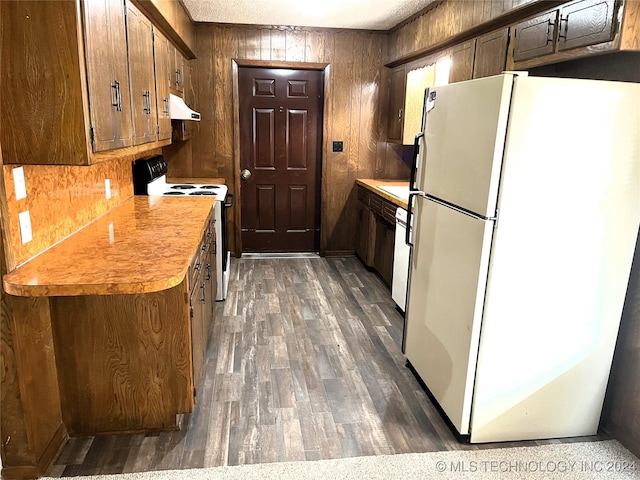 2912 Michelle, Durant, OK 74701 - kitchen featuring light countertops, freestanding refrigerator, under cabinet range hood, range with electric stovetop, and wood finished floors