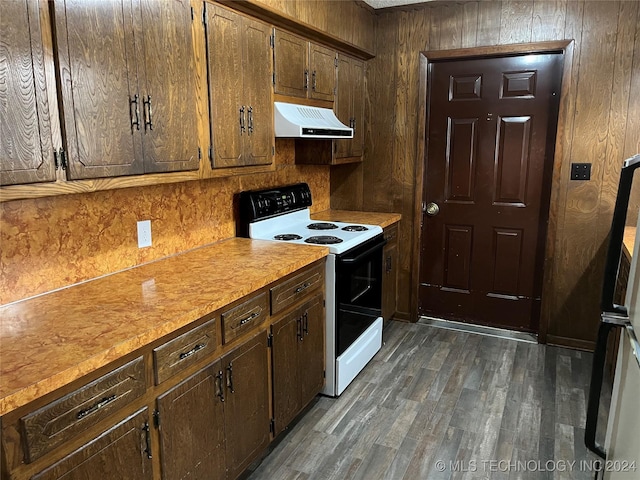 2912 Michelle, Durant, OK 74701 - kitchen featuring dark wood-style flooring, light countertops, electric range, exhaust hood, and wood walls