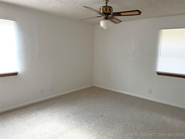 2912 Michelle, Durant, OK 74701 - carpeted empty room with baseboards, a textured ceiling, a ceiling fan, and a healthy amount of sunlight