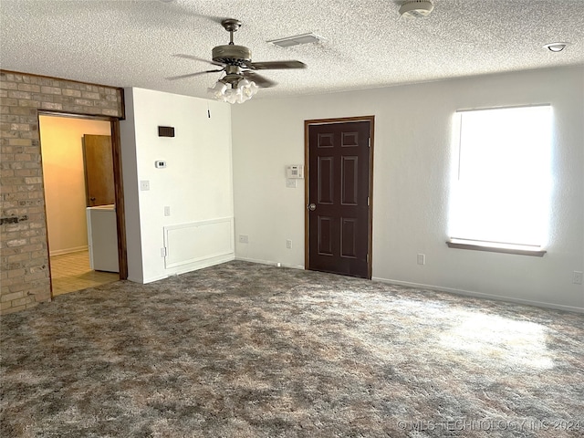 empty room with carpet floors, ceiling fan, and a textured ceiling