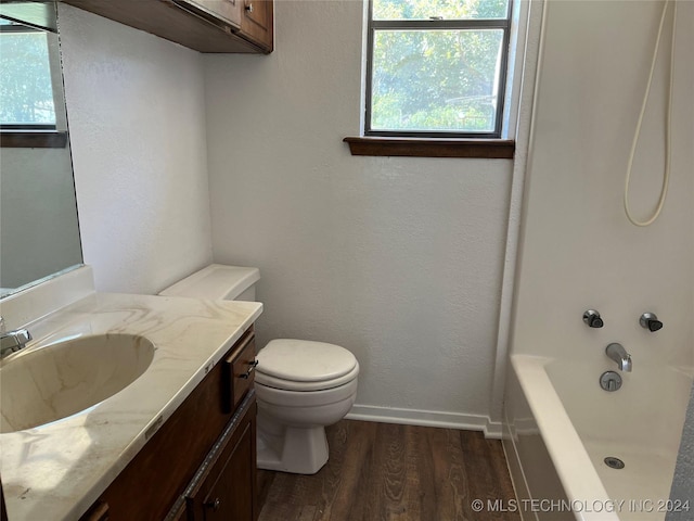 2912 Michelle, Durant, OK 74701 - full bath with bathtub / shower combination, vanity, toilet, wood finished floors, and baseboards