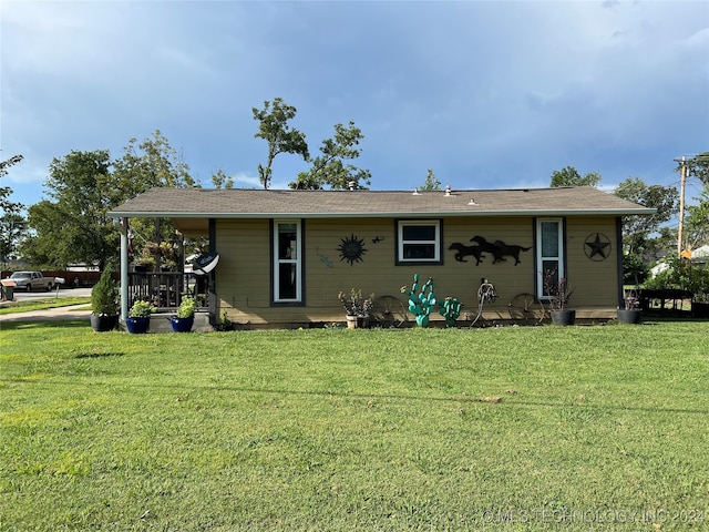 back of property featuring a yard