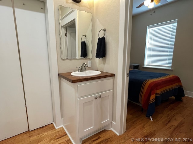 bathroom featuring hardwood / wood-style floors, ceiling fan, and vanity