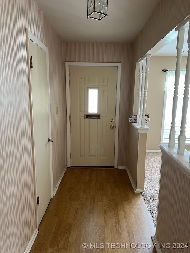 doorway with light carpet and decorative columns