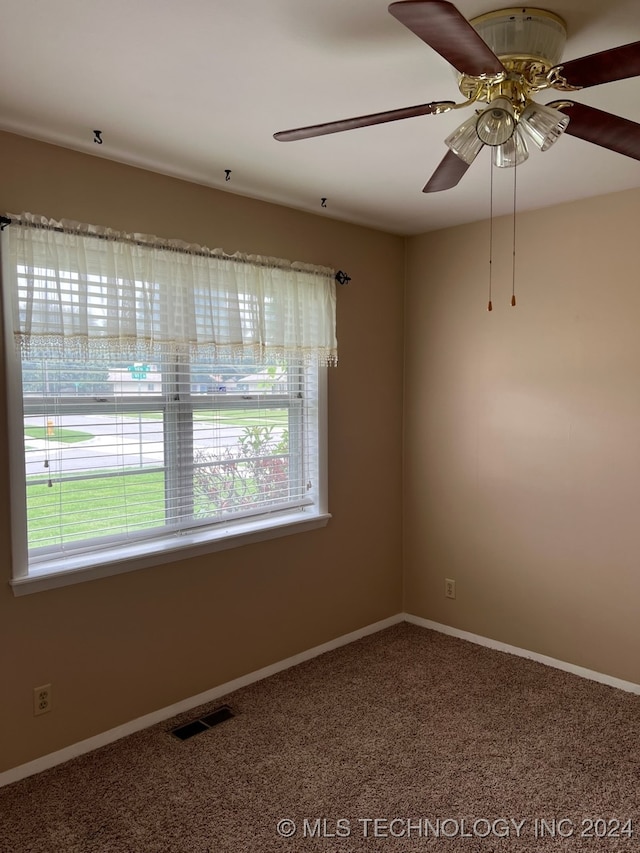 unfurnished room with plenty of natural light, ceiling fan, and carpet floors