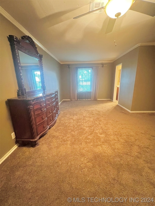 unfurnished bedroom with ceiling fan, carpet, and ornamental molding