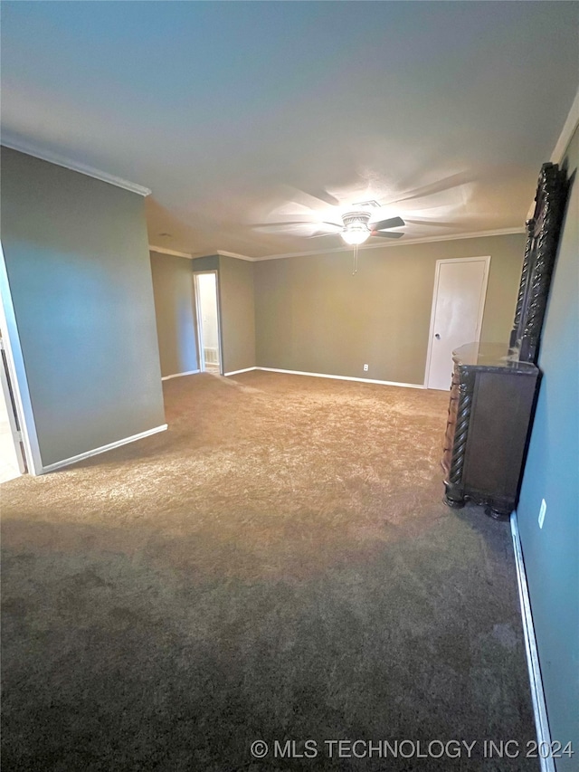 carpeted empty room featuring ceiling fan and crown molding