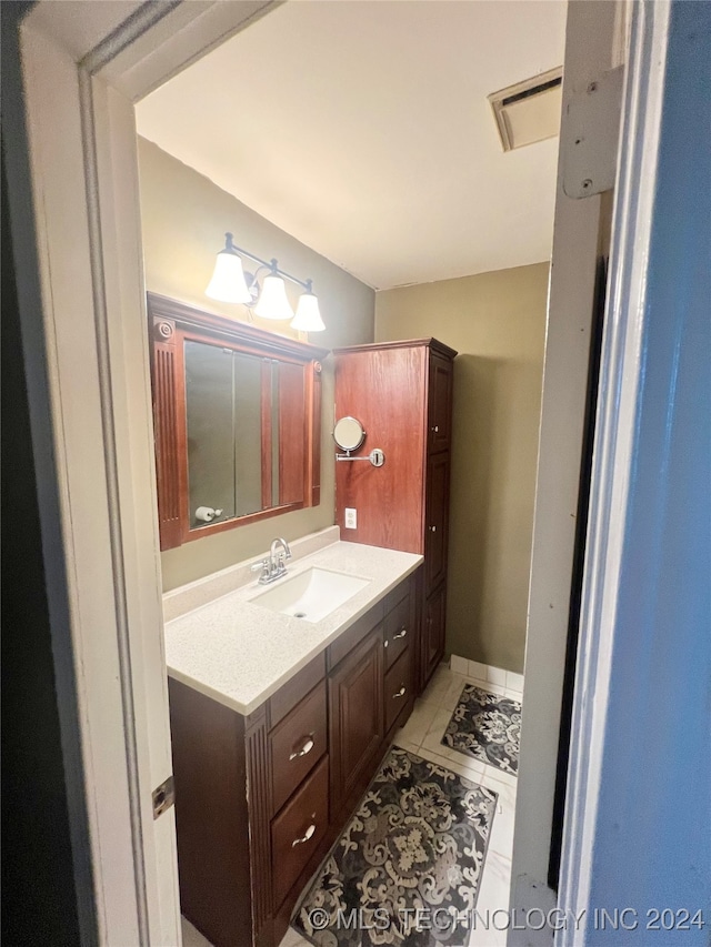 bathroom featuring tile patterned flooring and vanity