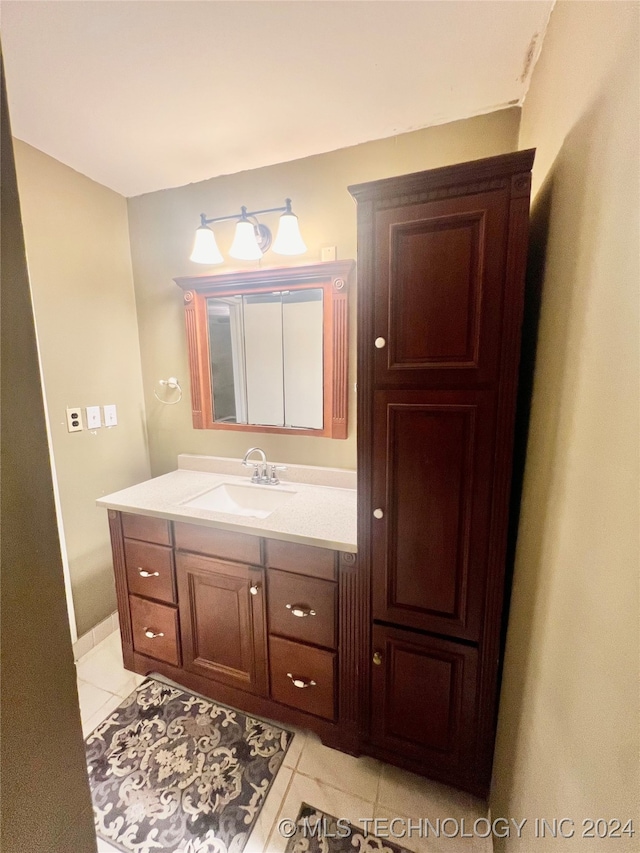 bathroom with tile patterned flooring and vanity