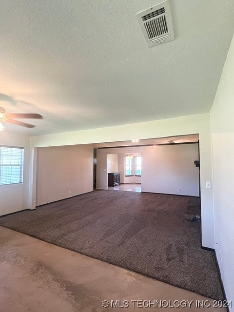 bonus room with a textured ceiling, ceiling fan, and carpet floors