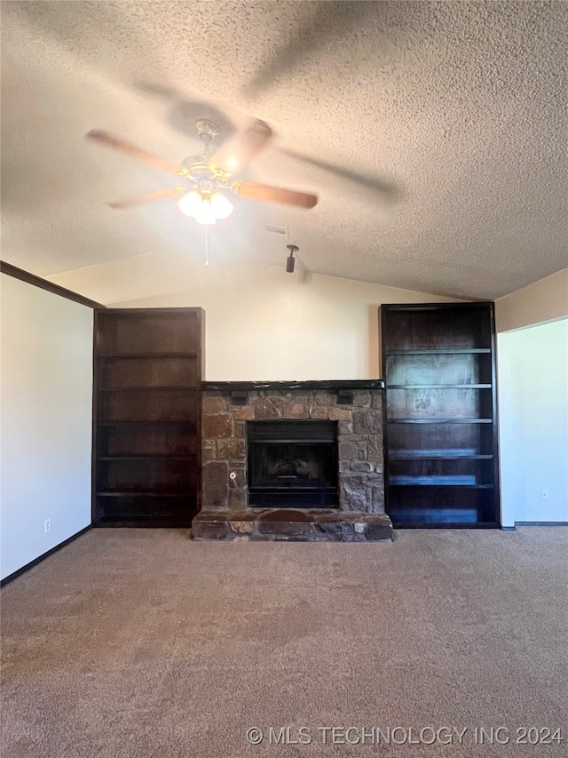 unfurnished living room with a fireplace, a textured ceiling, ceiling fan, and carpet flooring