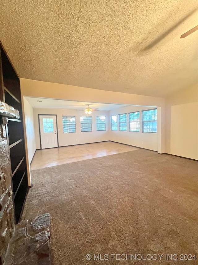 unfurnished living room featuring a textured ceiling and ceiling fan