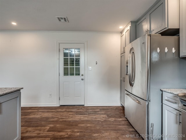 kitchen with gray cabinetry, stainless steel fridge, dark hardwood / wood-style floors, and light stone countertops