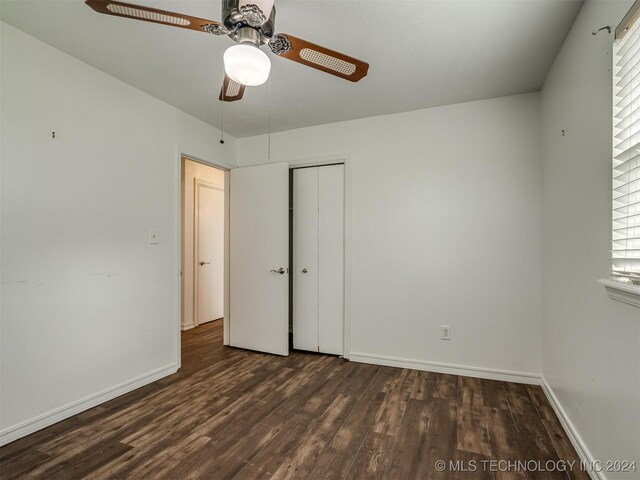 unfurnished bedroom with ceiling fan, wood-type flooring, and a closet