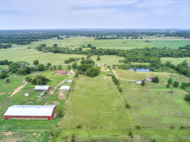 birds eye view of property featuring a rural view and a water view