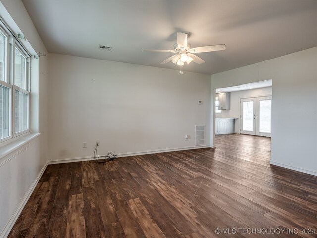 unfurnished room with ceiling fan, hardwood / wood-style floors, and french doors