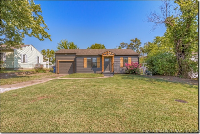 view of front of property with a garage and a front yard