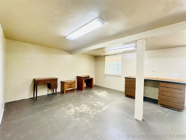 basement featuring a textured ceiling