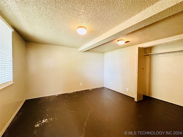 empty room featuring concrete floors and a textured ceiling