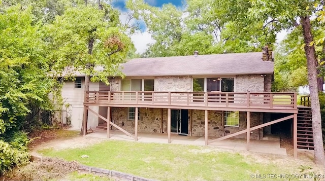 rear view of house featuring a deck and a patio area