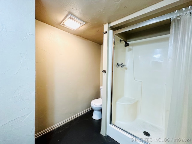 bathroom with a shower and toilet